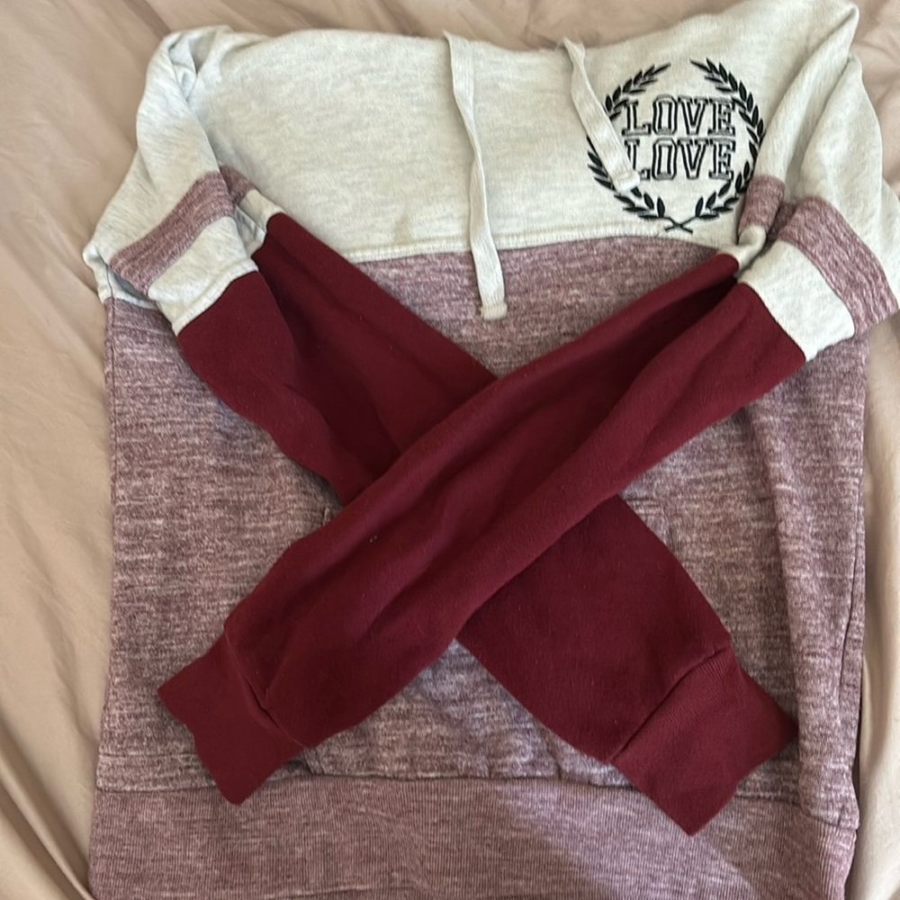 It’s a medium women’s pink sweater with hood